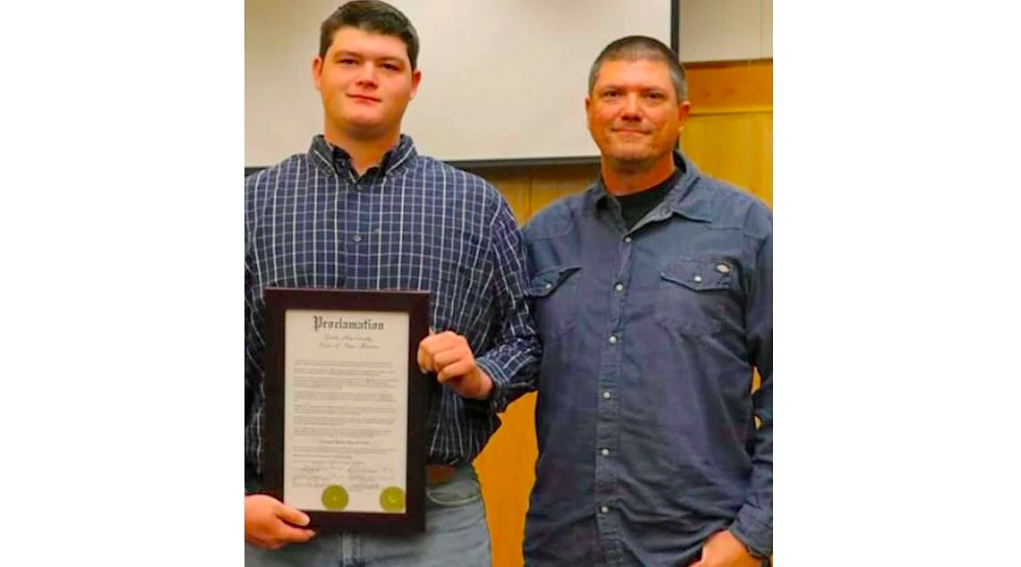 Two people smile for the camera