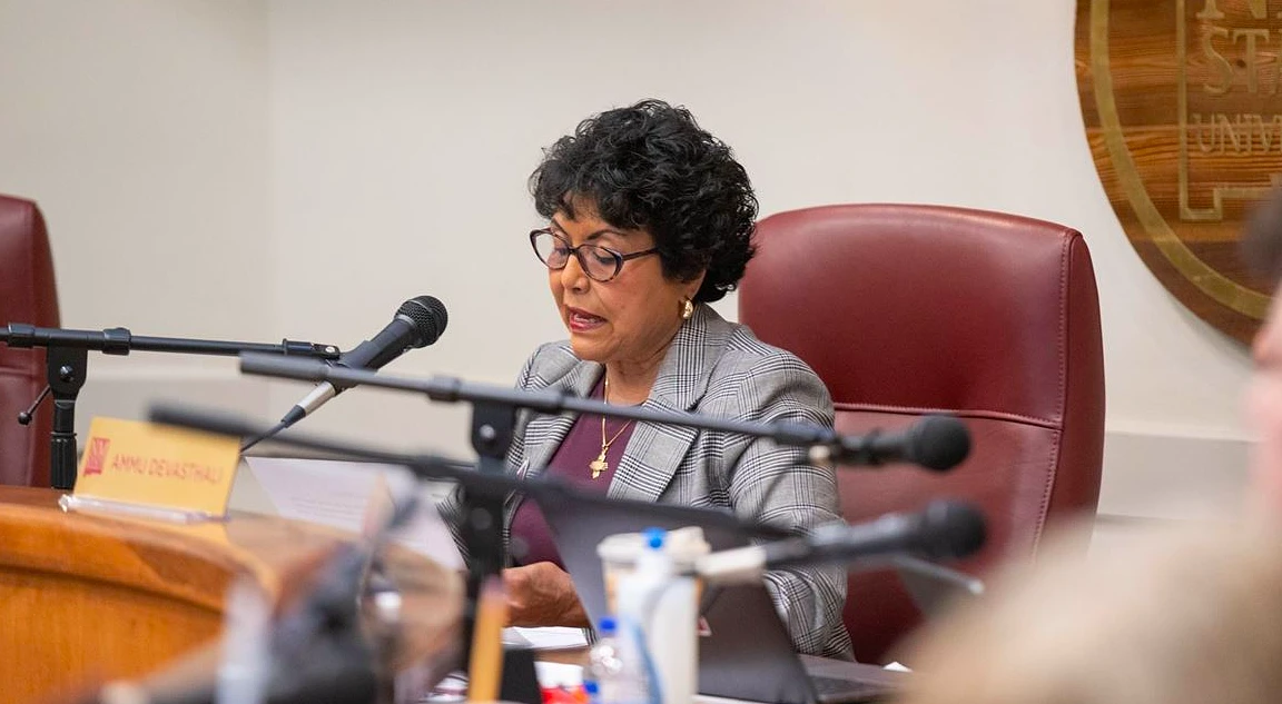 A woman speaks into a microphone